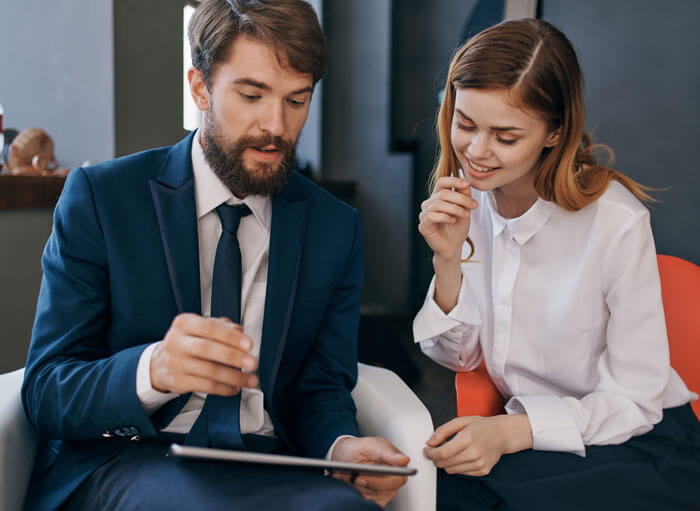 colleagues-communicate-with-tablet-technology-office